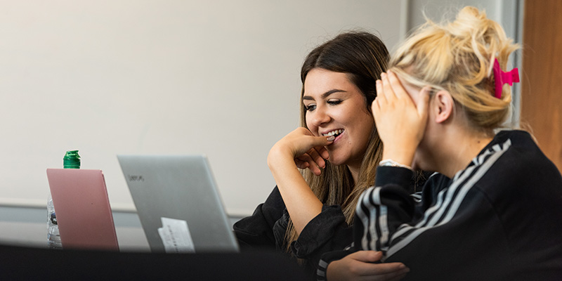 Two students looking at laptop