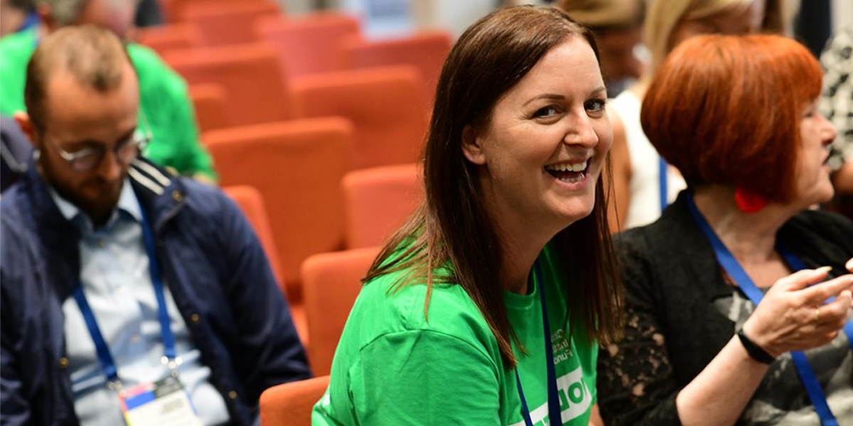 a ciof volunteer sat in a lecture theatre smiling at the camera