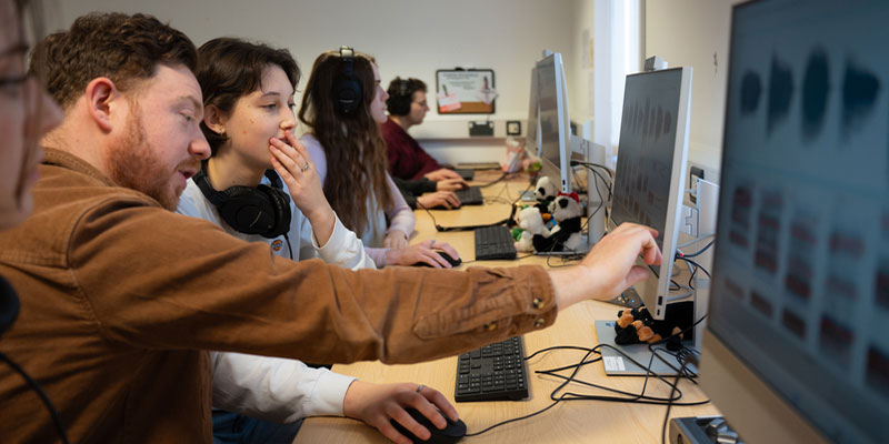 An academic working with a student in the forensics lab.