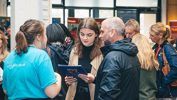Student Ambassador talking to guests at an Open Day.