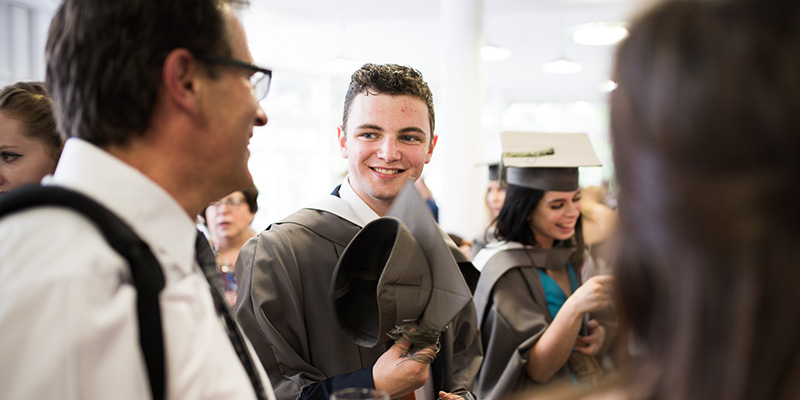 Student after graduation in conversation.