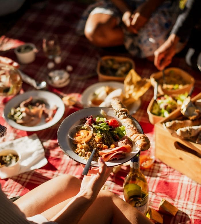 people having a picnic with a plate of food