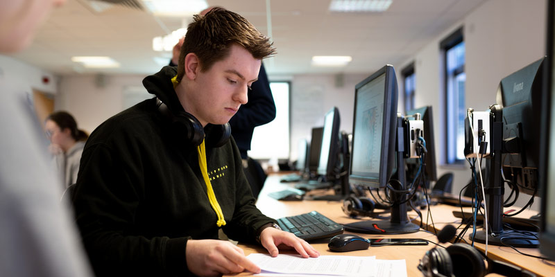 A postgraduate researcher working on a computer.